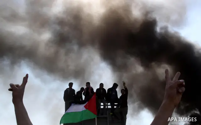 Palestinian protesters shout during a protest marking Land Day, near the border between Israel and the northern Gaza Strip March 30, 2012. Israeli security forces fired rubber bullets, tear gas and stun grenades to break...