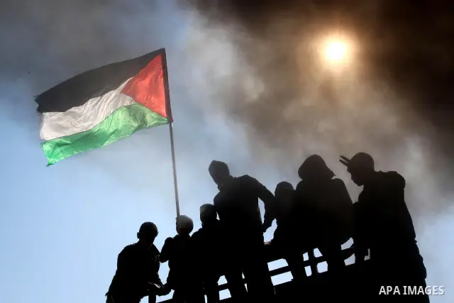 Palestinian protesters shout during a protest marking Land Day, near the border between Israel and the northern Gaza Strip March 30, 2012. Israeli security forces fired rubber bullets, tear gas and stun grenades to break...