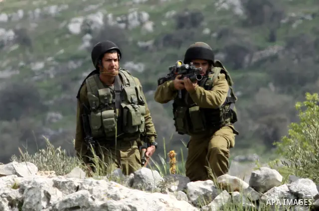 Israeli soldiers fire tear gas canisters towards Palestinian protesters during a demonstration to mark the anniversary of Land Day in the village Iraq Burin, near town of Nablus in the occupied Israeli West bank on March...