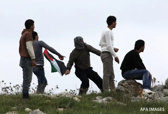 Palestinian protesters throw stones at Israeli soldiers during a demonstration to mark the anniversary of Land Day in the village Iraq Burin, near town of Nablus in the occupied Israeli West bank on March 30, 2012. Land...