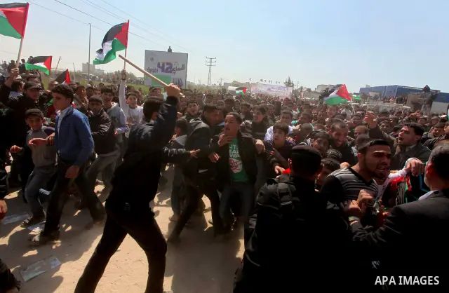 Members of Hamas security forces prevent Palestinian protesters from reaching the border between Israel and the northern Gaza Strip, after a protest marking Land Day March 30, 2012. Israeli security forces fired rubber b...