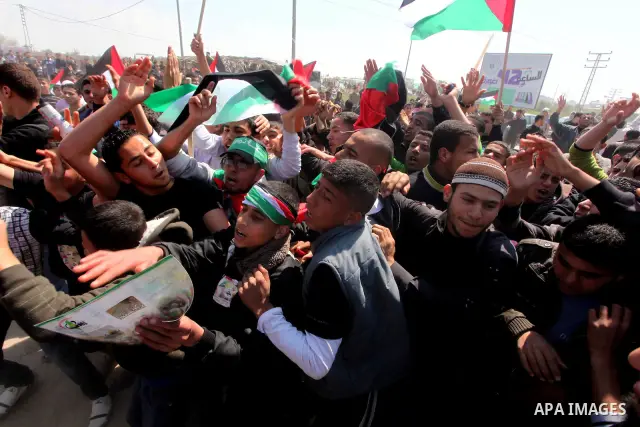 Members of Hamas security forces prevent Palestinian protesters from reaching the border between Israel and the northern Gaza Strip, after a protest marking Land Day March 30, 2012. Israeli security forces fired rubber b...