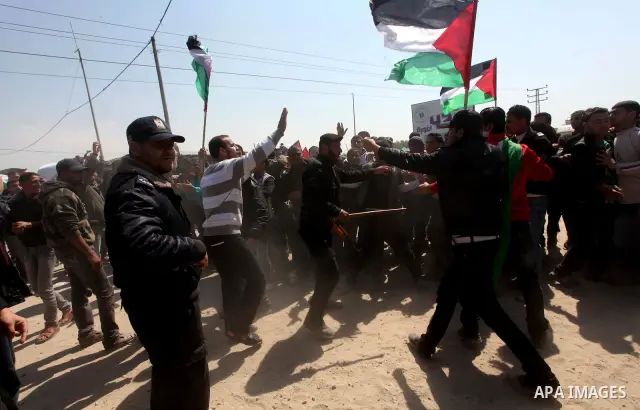 Members of Hamas security forces prevent Palestinian protesters from reaching the border between Israel and the northern Gaza Strip, after a protest marking Land Day March 30, 2012. Israeli security forces fired rubber b...