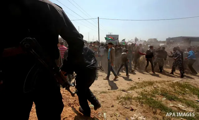 Members of Hamas security forces prevent Palestinian protesters from reaching the border between Israel and the northern Gaza Strip, after a protest marking Land Day March 30, 2012. Israeli security forces fired rubber b...