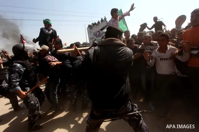 Members of Hamas security forces prevent Palestinian protesters from reaching the border between Israel and the northern Gaza Strip, after a protest marking Land Day March 30, 2012. Israeli security forces fired rubber b...