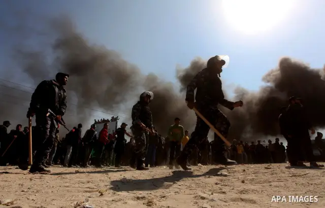 Members of Hamas security forces prevent Palestinian protesters from reaching the border between Israel and the northern Gaza Strip, after a protest marking Land Day March 30, 2012. Israeli security forces fired rubber b...