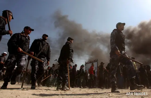 Members of Hamas security forces prevent Palestinian protesters from reaching the border between Israel and the northern Gaza Strip, after a protest marking Land Day March 30, 2012. Israeli security forces fired rubber b...