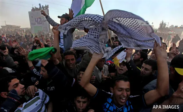 Palestinian protesters shout during a protest marking Land Day, near the border between Israel and the northern Gaza Strip March 30, 2012. Israeli security forces fired rubber bullets, tear gas and stun grenades to break...