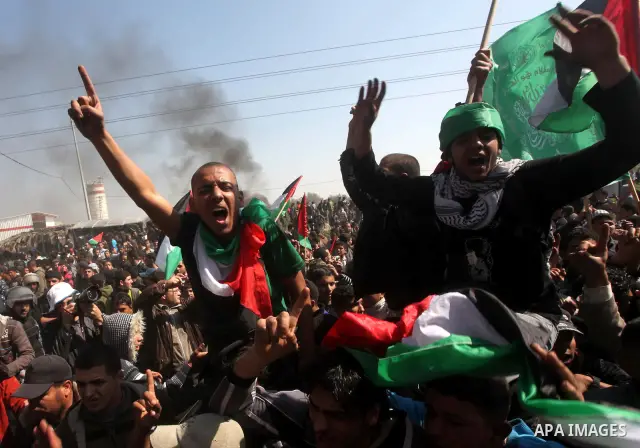 Palestinian protesters shout during a protest marking Land Day, near the border between Israel and the northern Gaza Strip March 30, 2012. Israeli security forces fired rubber bullets, tear gas and stun grenades to break...