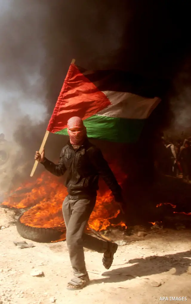 Palestinian protesters shout during a protest marking Land Day, near the border between Israel and the northern Gaza Strip March 30, 2012. Israeli security forces fired rubber bullets, tear gas and stun grenades to break...