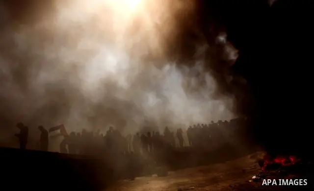 Palestinian protesters shout during a protest marking Land Day, near the border between Israel and the northern Gaza Strip March 30, 2012. Israeli security forces fired rubber bullets, tear gas and stun grenades to break...