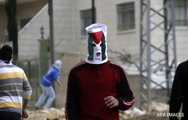 Palestinian protesters throw stones at Israeli soldiers during a demonstration to mark the anniversary of Land Day in the village Kafr Qaddum, close to the northern town of Nablus in the occupied Israeli West bank on Mar...