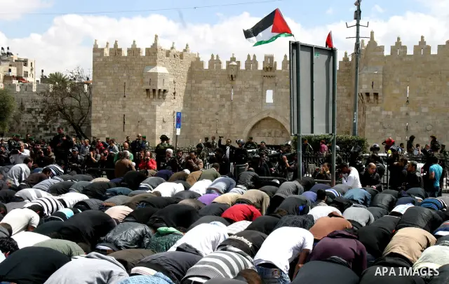 Palestinians pray on the street after they were prevented from attending prayers at Al-Aqsa mosque on Land Day , outside Damascus Gate in Jerusalem's Old City, Friday, March 30, 2012. Israeli security forces fired rubber...