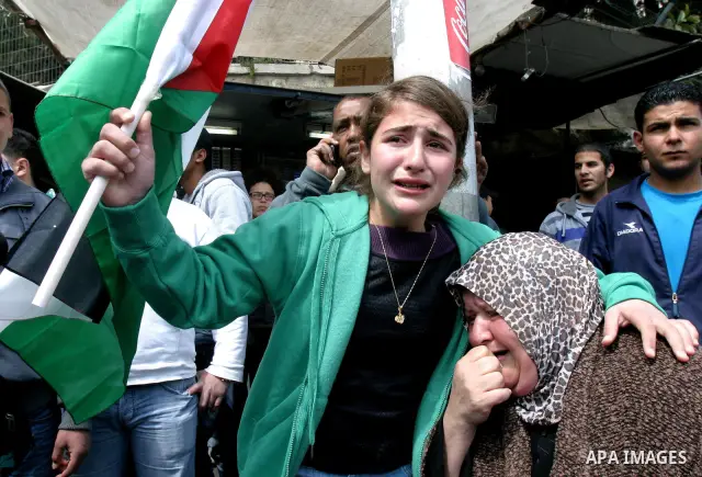 Palestinian protesters take part in a demonstration on Land Day outside Damascus Gate in Jerusalem's Old City March 30, 2012. Israeli security forces fired rubber bullets, tear gas and stun grenades to break up groups of...