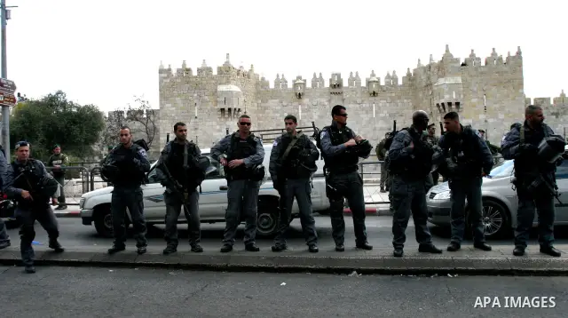 Israeli security officers stand guard before Friday prayers on Land Day outside Damascus Gate in Jerusalem's Old City March 30, 2012. Israeli security forces fired rubber bullets, tear gas and stun grenades to break up g...