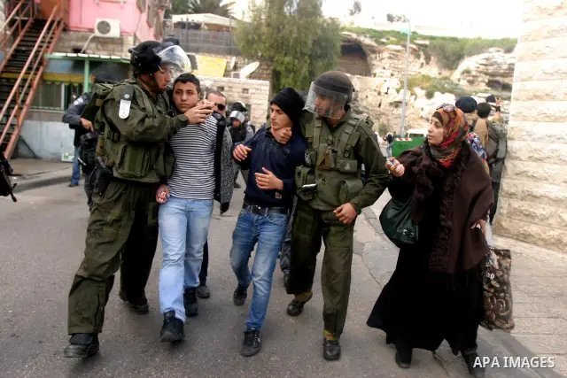 Israeli border police officers detain Palestinian protesters during clashes on Land Day after Friday prayers outside Damascus Gate in Jerusalem's Old City March 30, 2012. Israeli security forces fired rubber bullets, tea...