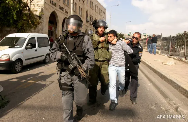 Israeli border police officers detain a Palestinian protester during clashes on Land Day after Friday prayers outside Damascus Gate in Jerusalem's Old City March 30, 2012. Israeli security forces fired rubber bullets, te...