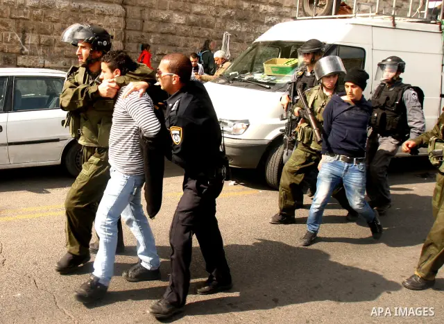 Israeli border police officers detain Palestinian protesters during clashes on Land Day after Friday prayers outside Damascus Gate in Jerusalem's Old City March 30, 2012. Israeli security forces fired rubber bullets, tea...