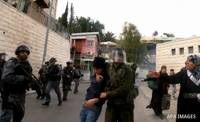 Israeli border police officers detain Palestinian protesters during clashes on Land Day after Friday prayers outside Damascus Gate in Jerusalem's Old City March 30, 2012. Israeli security forces fired rubber bullets, tea...