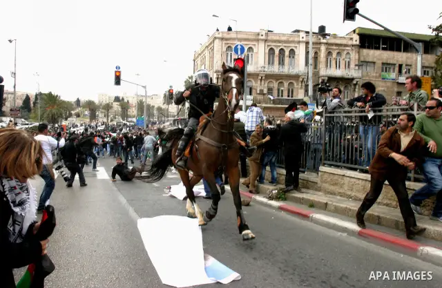 Israeli police officers on horseback scuffle with Palestinians during clashes on Land Day after Friday prayers outside Damascus Gate in Jerusalem's Old City March 30, 2012. Israeli security forces fired rubber bullets, t...