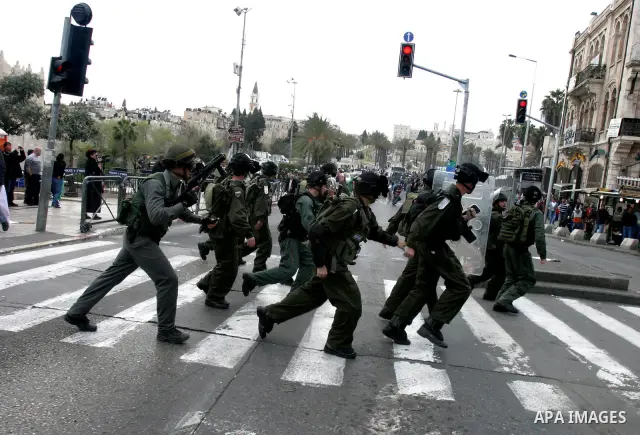 Israeli police officers scuffle with Palestinians during clashes on Land Day after Friday prayers outside Damascus Gate in Jerusalem's Old City March 30, 2012. Israeli security forces fired rubber bullets, tear gas and s...