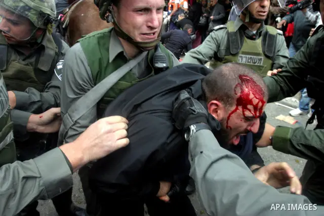 Israeli border police officers detain an injured Palestinian protester during clashes on Land Day after Friday prayers outside Damascus Gate in Jerusalem's Old City March 30, 2012. Israeli security forces fired rubber bu...