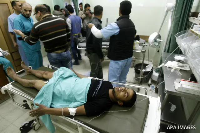 A wounded Palestinian receives medical care at a hospital in Khan Yunis, after being injured during protests on Land Day close to the border with Israel in the eastern Gaza Strip Friday, March 30, 2012. Israeli security...