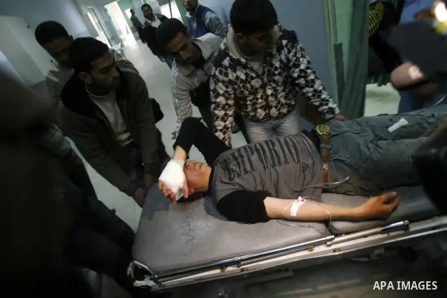 A wounded Palestinian receives medical care at a hospital in Khan Yunis, after being injured during protests on Land Day close to the border with Israel in the eastern Gaza Strip Friday, March 30, 2012. Israeli security...
