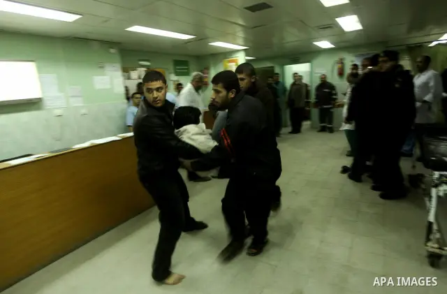 A wounded Palestinian receives medical care at a hospital in northern Gaza Strip, after being injured during protests on Land Day close to the border with Israel in the northern Gaza Strip Friday, March 30, 2012. Israeli...