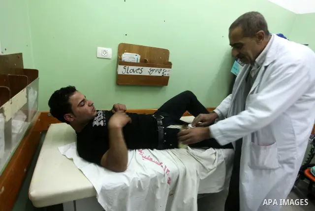 A wounded Palestinian receives medical care at a hospital in northern Gaza Strip, after being injured during protests on Land Day close to the border with Israel in the northern Gaza Strip Friday, March 30, 2012. Israeli...