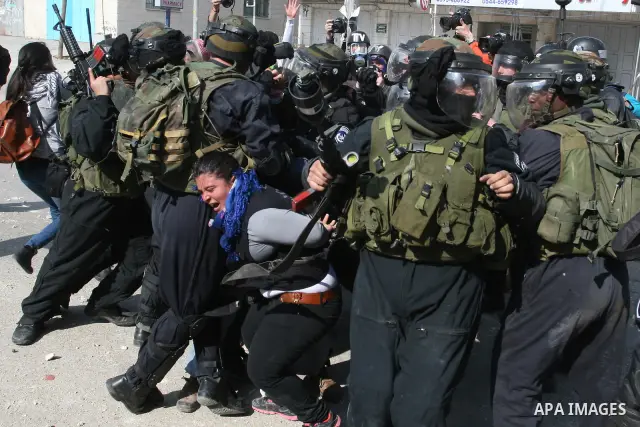 Foreign activists scuffle with Israeli security forces during clashes at a demonstration marking Land Day, at Qalandiya checkpoint, near the West Bank city of Ramallah March 30, 2012. Israeli security forces fired rubber...
