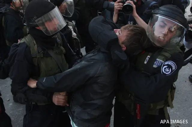 Foreign activists scuffle with Israeli security forces during clashes at a demonstration marking Land Day, at Qalandiya checkpoint, near the West Bank city of Ramallah March 30, 2012. Israeli security forces fired rubber...