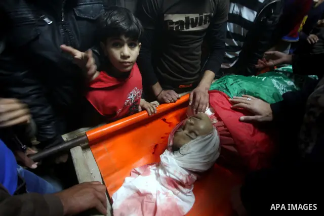 Palestinians gather around the body of 20-year-old Mahmoud Zakot during his funeral in the northern Gaza Strip March 30, 2012. Israeli security forces shot dead Zakot in the Gaza Strip on Friday, medics said, and clashed...