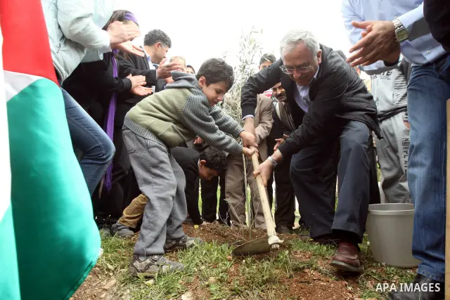 Palestinian Prime Minister, Salam Fayyad, participates during the cultivation of olive trees on the occasion of "Land Day", in the West Bank city of Bethlehem, on Mar. 31, 2012. Photo by Mustafa Abu Dayah