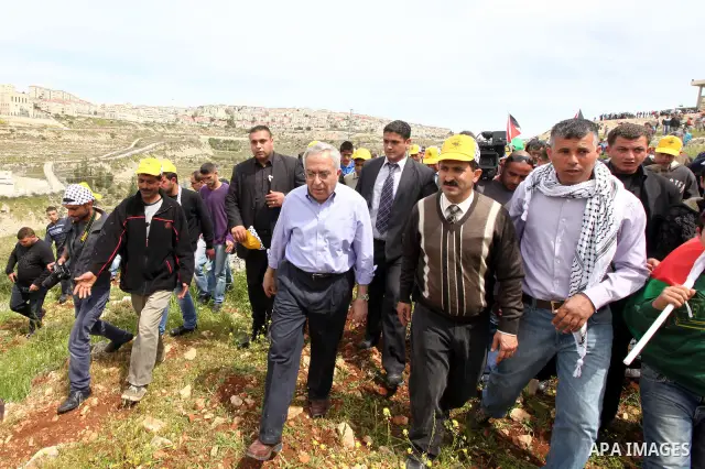 Palestinian Prime Minister, Salam Fayyad, participates during the cultivation of olive trees on the occasion of "Land Day", in the West Bank city of Bethlehem, on Mar. 31, 2012. Photo by Mustafa Abu Dayah