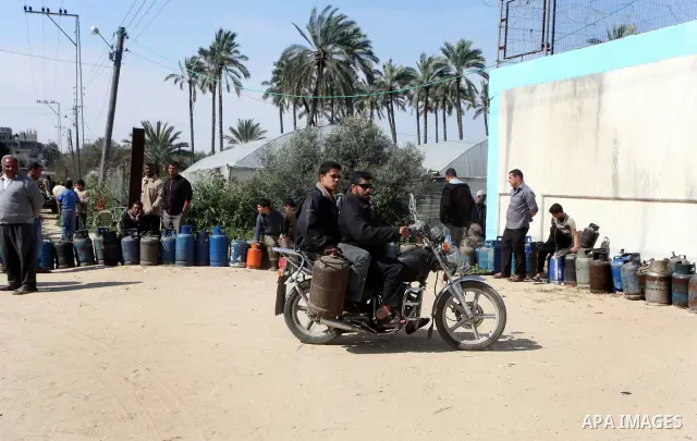 Palestinians wait to fill canisters with cooking gas outside a filling station in Deir al-Balah, in the central Gaza Strip, April 1, 2012. Palestinians in the Gaza Strip are experiencing shortage in gas and fuel. Photo b...