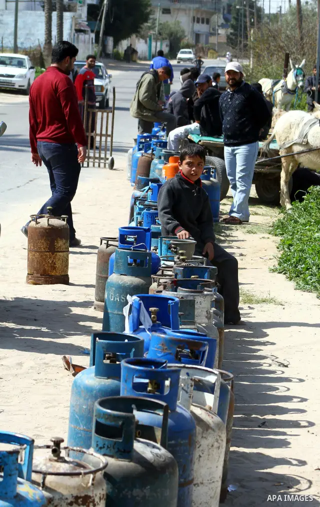 Palestinians wait to fill canisters with cooking gas outside a filling station in Deir al-Balah, in the central Gaza Strip, April 1, 2012. Palestinians in the Gaza Strip are experiencing shortage in gas and fuel. Photo b...