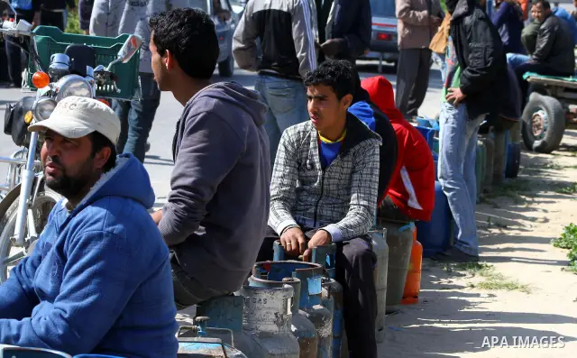 Palestinians wait to fill canisters with cooking gas outside a filling station in Deir al-Balah, in the central Gaza Strip, April 1, 2012. Palestinians in the Gaza Strip are experiencing shortage in gas and fuel. Photo b...