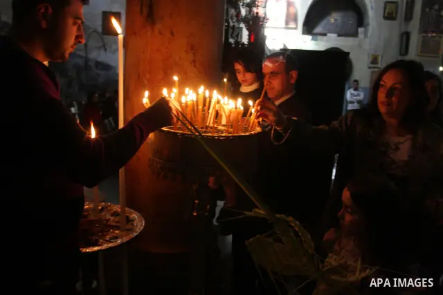 Palestinians Catholic attend a Palm Sunday at a church "Nativity" in Bethlehem in the West Bank in, Sunday, April 1, 2012. Palm Sunday commemorates Jesus Christ's triumphant entry into Jerusalem when his followers laid p...
