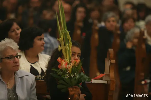Palestinians Catholic attend a Palm Sunday at a church "Nativity" in Bethlehem in the West Bank in, Sunday, April 1, 2012. Palm Sunday commemorates Jesus Christ's triumphant entry into Jerusalem when his followers laid p...