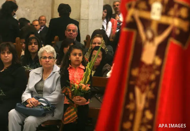 Palestinians Catholic attend a Palm Sunday at a church "Nativity" in Bethlehem in the West Bank in, Sunday, April 1, 2012. Palm Sunday commemorates Jesus Christ's triumphant entry into Jerusalem when his followers laid p...