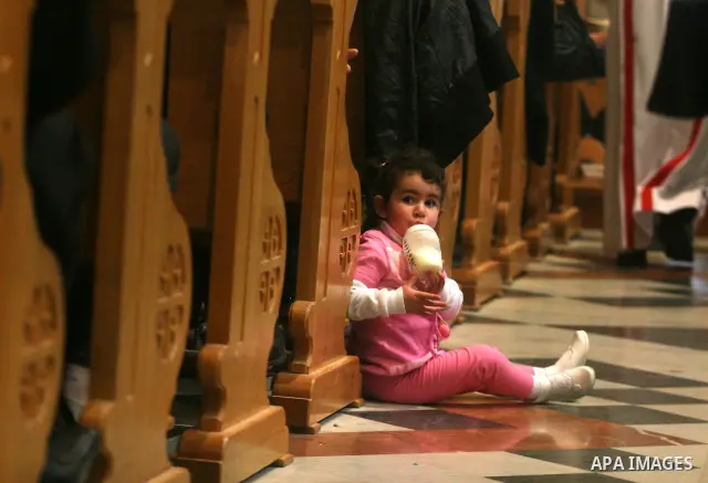 Palestinians Catholic attend a Palm Sunday at a church "Nativity" in Bethlehem in the West Bank in, Sunday, April 1, 2012. Palm Sunday commemorates Jesus Christ's triumphant entry into Jerusalem when his followers laid p...