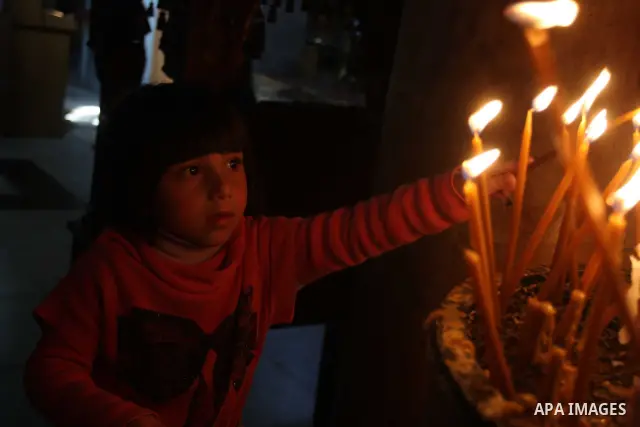 Palestinians Catholic attend a Palm Sunday at a church "Nativity" in Bethlehem in the West Bank in, Sunday, April 1, 2012. Palm Sunday commemorates Jesus Christ's triumphant entry into Jerusalem when his followers laid p...