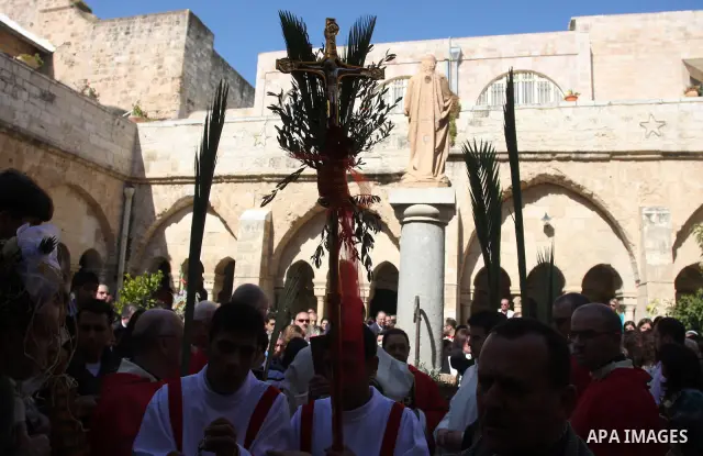 Palestinians Catholic attend a Palm Sunday at a church "Nativity" in Bethlehem in the West Bank in, Sunday, April 1, 2012. Palm Sunday commemorates Jesus Christ's triumphant entry into Jerusalem when his followers laid p...