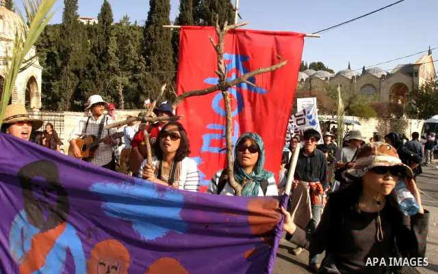 Christian pilgrims march during the traditional Palm Sunday procession from the Mount of Olives to Jerusalem's old city on April 1, 2012. Photo by Mahfouz Abu Turk