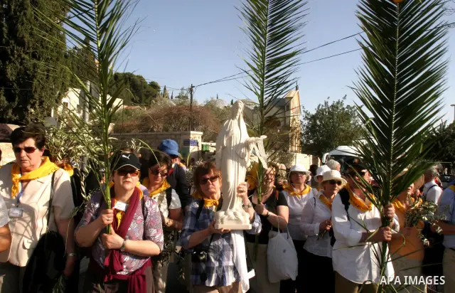 Christian pilgrims march during the traditional Palm Sunday procession from the Mount of Olives to Jerusalem's old city on April 1, 2012. Photo by Mahfouz Abu Turk