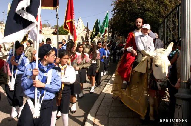Christian pilgrims march during the traditional Palm Sunday procession from the Mount of Olives to Jerusalem's old city on April 1, 2012. Photo by Mahfouz Abu Turk