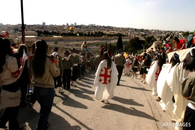 Christian pilgrims march during the traditional Palm Sunday procession from the Mount of Olives to Jerusalem's old city on April 1, 2012. Photo by Mahfouz Abu Turk