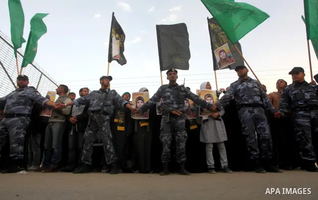 Palestinians hold posters of Hanaa Shalabi, a prisoner who spent 43 days on hunger strike, as they wait to greet her near the Erez border crossing between Israel and the northern Gaza Strip on April 1, 2012. Shalabi, who...