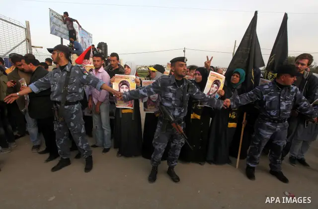 Palestinians hold posters of Hanaa Shalabi, a prisoner who spent 43 days on hunger strike, as they wait to greet her near the Erez border crossing between Israel and the northern Gaza Strip on April 1, 2012. Shalabi, who...